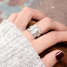 a woman's hand with two rings on her fingers