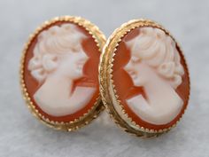 These cameo studs are simply charming! Classic bezel settings of 14 karat gold are accented by beaded edging that catches the light beautifully. These demure ladies have flowing curls in their hair that emphasizes the feminine style of these earrings.Metal: 14K Yellow GoldGem: Shell CameoGem Measurements: 12.2 x 9.9 mm, OvalEarrings Length: 14 mmEarrings Width: 12 mmMarks: “14K” Stamped on the Findings Wedding Jewelry With Screw Back, Heirloom Style Earrings For Formal Occasions, Classic Cameo Earrings For Wedding, Formal Screw Back Earrings, Elegant Cameo Earrings For Wedding, Elegant Round Cameo Earrings, Gold Cameo Earrings For Wedding, Gold Cameo Round Earrings, Elegant Cameo Clip-on Earrings Gift