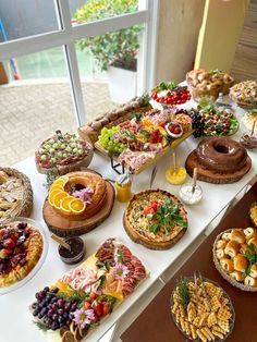 an assortment of desserts and pastries on a buffet table