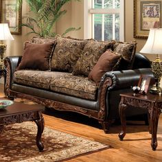 a living room filled with furniture and pillows on top of a hard wood flooring