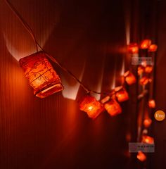 lanterns are hanging on the wall with string lights