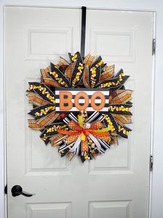 a decorated door hanger with the word boo on it