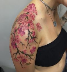 a woman's arm with pink flowers on it