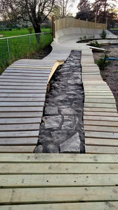 a wooden walkway that has been built into the ground