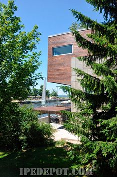 the building is made out of wood and has a large window on it's side