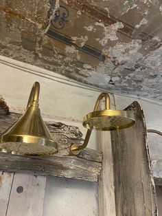 an old light fixture hanging from the ceiling in a run down room with peeling paint