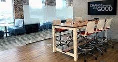 a conference room with chairs and a table in front of a large sign that reads change for good