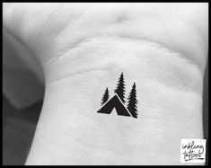 a black and white photo of a small triangle with trees on the side of it