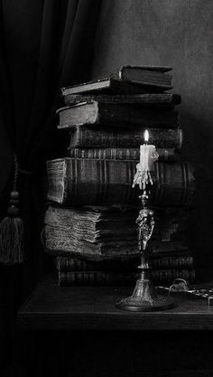 a candle and some books on a table