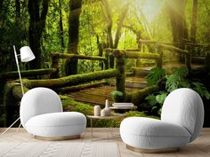 an image of a forest scene with mossy trees on the wall and white chairs