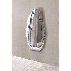 a mirror hanging on the side of a wall