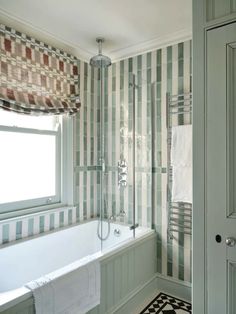 a bathroom with green and white striped walls