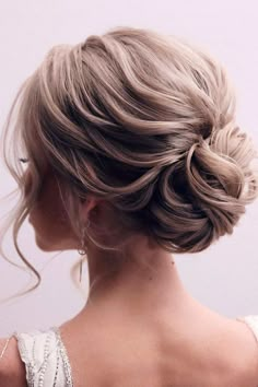 a woman with blonde hair in a low bun