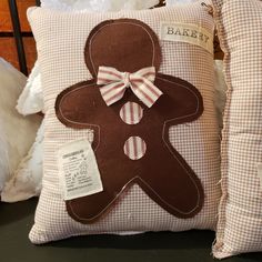 a pillow with a gingerbread man on it and a bow tie around the neck