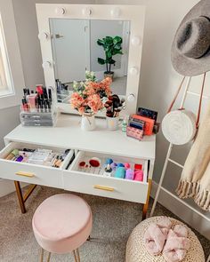 a white vanity with drawers and lots of makeup