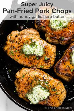 four pieces of chicken in a skillet with parmesan cheese and herbs on top