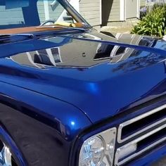 a blue truck parked in front of a house