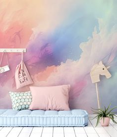 a room with a blue couch and pink wall