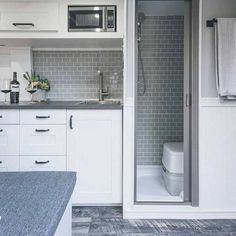 a bathroom with a sink, toilet and shower in it's stall door area