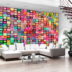 a living room filled with furniture and a large colorful wall