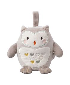 an owl stuffed animal sitting on top of a white surface