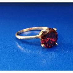 * Vintage Designer 14k Yellow Gold Round Red Quartz Solitaire January Ring * Ring Size: 6.0 * Top Of Ring Measures: 3/8" X 3/8" * Height: 3/8" * Band Measures: 1/16" * Red Quartz Total Carat Weight: Approximately 1.80 Tcw * Weight: 2.3 Tgw * Marked: 14k*Makers Mark * Condition: Great * G1059 Classic Red Jewelry As A Gift, Fine Jewelry Red Ruby Ring Gift, Red Ruby Ring Fine Jewelry Gift, Luxury Red Birthstone Ring With Gemstone, Classic Red Ruby Ring In 14k Gold, Fine Jewelry Garnet Ring, Red Solitaire Ruby Ring As A Gift, Gift Red Ruby Ring With Prong Setting, Classic Red Birthstone Jewelry