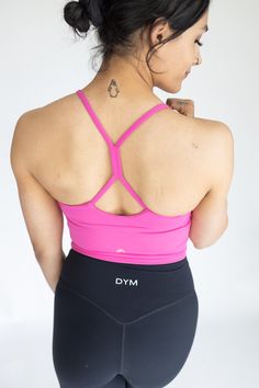 IDEAL FOR: Yoga + Barre + Pilates, Dance, Low Impact Workout, Cardio, Casual Wear. FEELS LIKE: Designed with a lightweight fabric which is incredibly soft and features 4-way stretch and high retention. WHY WE LOVE THEM: Just like our original Fan-favorite Solar Tank- but with extended tummy coverage, size options, and sporting our gold logo! We LOVE this top because it can be worn on it's own as a tank or layered underneath as a bra. This top features a flattering V-neckline with a unique gather Racerback Activewear With Built-in Bra For Light Exercise, Compressive T-back Activewear For Workout, 4-way Stretch Cross Back Activewear For Gym, Moisture-wicking 4-way Stretch Activewear With Strappy Back, Compressive T-back Activewear For Gym, Cross Back Stretch Activewear For Gym, Stretch Cross Back Activewear For Gym, Stretch Cross-back Activewear For Gym, Cross Back Activewear With Built-in Bra And High Stretch