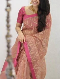 a woman in a pink sari with long hair