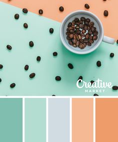 a cup filled with coffee beans sitting on top of a blue and orange color scheme