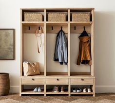 a coat rack with shoes and coats hanging on it