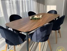 a wooden table surrounded by blue chairs