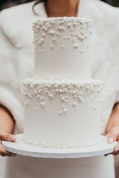 a close up of a person holding a cake