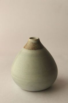 a white vase sitting on top of a table