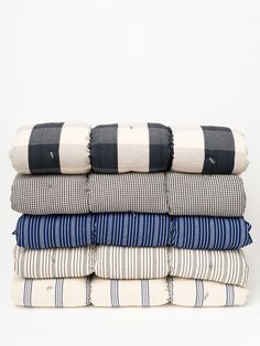 a stack of folded shirts sitting on top of each other