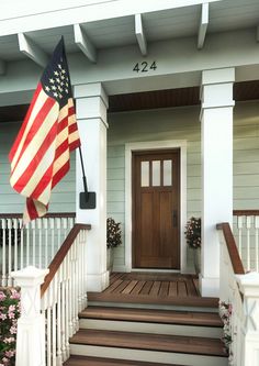 an american flag on the front porch of a house