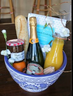 a blue and white bowl filled with food and condiments on top of a wooden table