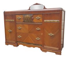 an old wooden dresser with two drawers and a mirror on it's top shelf