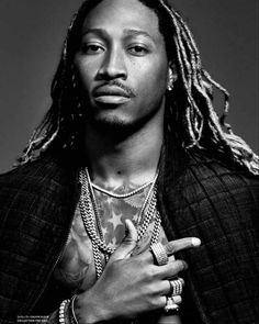 a black and white photo of a man with dreadlocks holding his hands together