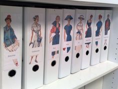 several binders with pictures of women's dresses on them in a store shelf