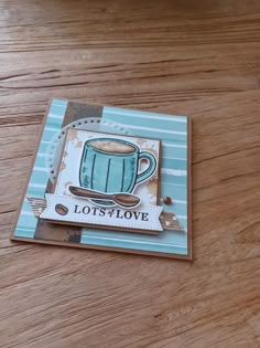 a close up of a card on a table with a cup of coffee in it