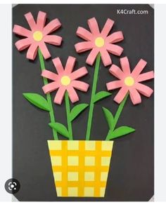 some pink flowers in a yellow vase on a black background with the words kk craft com