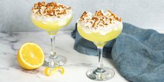 two glasses filled with lemonade and topped with whipped cream