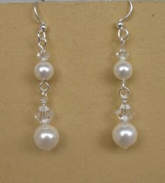 Pearl and Crystal Bridal Earrings ~ These pretty pearl dangle earrings are made with a 2 sizes of both swarovski pearls and crystals. Very delicate but still dramatic; adding the perfect accent without overwhelming you!  Earrings measure 2" from the top of the earwire. Options available at checkout for the earrings to be made in cream, white, or almond champagne pearls with either gold or silver finishes; however, any pearl and crystal color can be made as a custom order. Makes a lovely addition Cheap Elegant Beaded Drop Earrings, Cheap Pearl Beaded Earrings For Party, Cheap Dangling Pearl Earrings For Gift, Almond Champagne, Crystal Earrings Wedding, Crystal Bridal Earrings, Gift For Bridesmaids