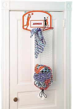 a door hanger with two basketballs and a tie hanging from it's side