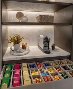 a shelf filled with lots of different types of chocolates and candy bars on top of it