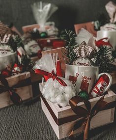 two boxes filled with christmas gifts on top of a carpeted floor next to each other