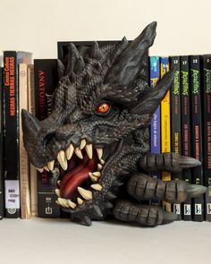 a book shelf with books and a dragon head