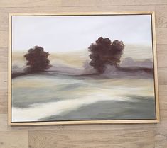 an oil painting on canvas of trees in the distance with white and gray colors, framed against a wooden wall