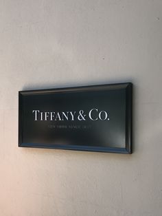 there is a sign on the wall that says tiffany & co