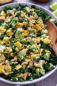 a bowl filled with corn and green vegetables